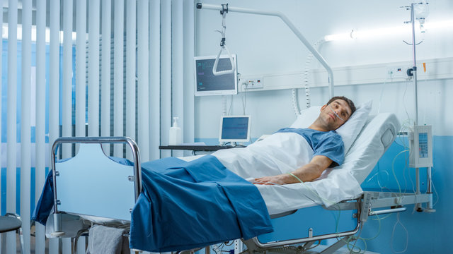 Sick Male Patient Lying On A Bed In The Private Ward In Hospital. White, Clean Environment.