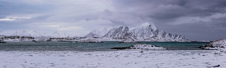 Landscape with beautiful winter sea and snowy mountains at Lofoten Islands in Northern Norway. Panoramic view
