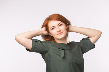 Young redhead woman posing on white background