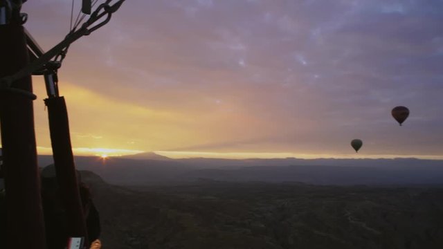 view from the basket of the balloon. against the background of dawn balloons are flying.