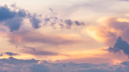 The evening sky with clouds at sunset is the beginning of the night