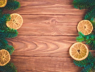 Festive table for the new year and Christmas with a Christmas tree, an orange and gifts
