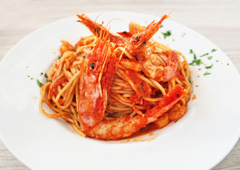 plate with shrimps, spaghetti and tomato sauce at a greek tavern - mediterranean seafood