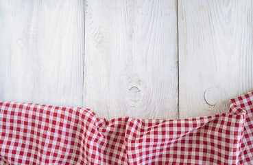 White and red checkered table lothe on white paint wooden background with copy space
