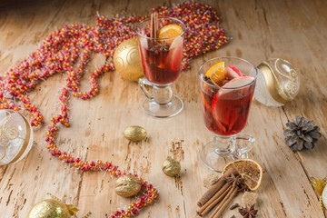 Сhristmas hot mulled wine with cinnamon cardamom and anise on wooden background