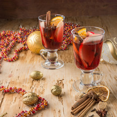 Сhristmas hot mulled wine with cinnamon cardamom and anise on wooden background