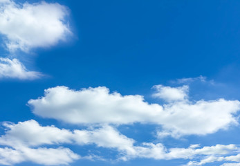 Blue sky background with white clouds.
