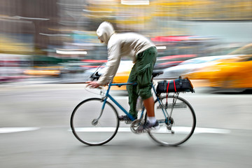 Fototapeta na wymiar cyclist in traffic on the city roadway motion blur
