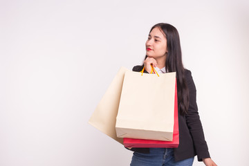 Young asian happy woman with shopping bags on white background with copy space