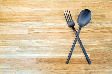 Wooden cutlery on a wooden background
top View of Spoon and Fork with Empty Tag, Placed on Wooden Table with Copy Space.