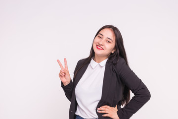 Obraz premium Beautiful young asian woman showing Victory Sign on white background with copy space