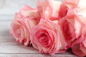 Beautiful bunch of pink roses for a gift lies on a light background. 