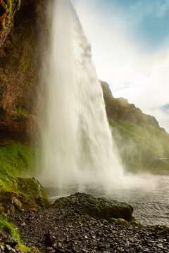 Famous waterfall Seljalandsfoss in Iceland, adventure outdoor travel Icelandic summer background © Roxana