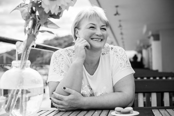 Portrait of attractive plus size mature woman in casual style walk at city at good sunny autumn day...