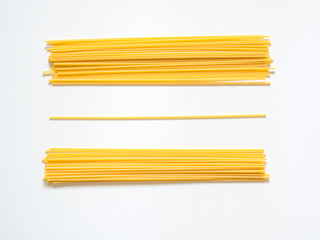 Dry spaghetti on a white background for the menu. Geometric background. Flat lay, copy space, top view - obrazy, fototapety, plakaty