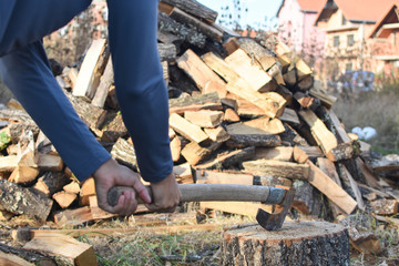 Lumberjack chopping wood for winter, Young man chopping woods with old ax