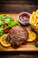 Grilled beefsteak with french fries and vegetables