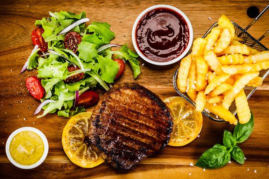 Grilled beefsteak with french fries and vegetables