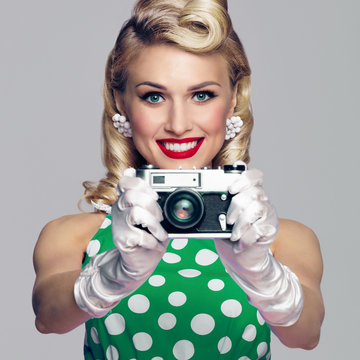 woman, with no-name camera, taking picture, dressed in pin-up style