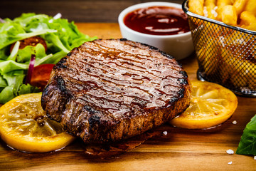 Grilled beefsteak with french fries and vegetables
