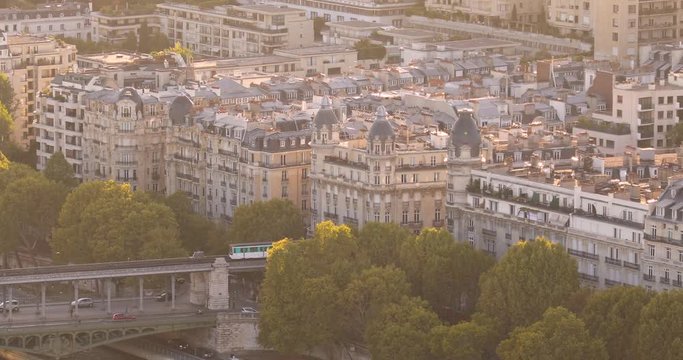 Aerial: The train is moving along the bridge in Paris, France
