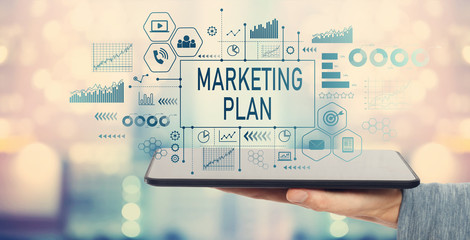 Marketing plan with man holding a tablet computer