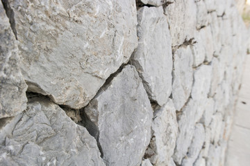Stone wall as a background or texture, old castle stone wall
