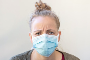 Portrait of a young woman in a medical mask. Protection against viruses.