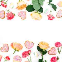 Frame made of roses flowers and petals with cookies and marshmallow on white background. Flat lay