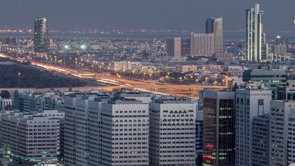 Aerial skyline of Abu Dhabi city centre from above day to night timelapse