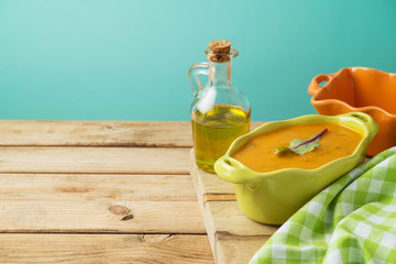 Pumpkin soup over rustic background
