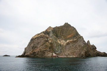 Fototapeta na wymiar Dokdo island where is beside Ulleungdo island is one of the famous tourist site where is made by volcano. There are varous oddly formed rocks and strangely shaped stones, and clean air in the East sea