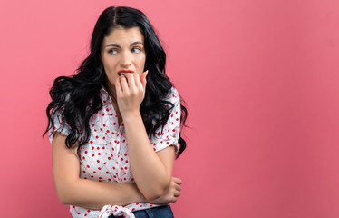 Worried young woman on a solid background