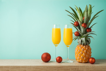 Christmas holiday concept with  pineapple as alternative Christmas tree and juice glasses
