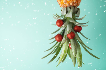 Christmas holiday concept with  pineapple as alternative Christmas tree with copy space
