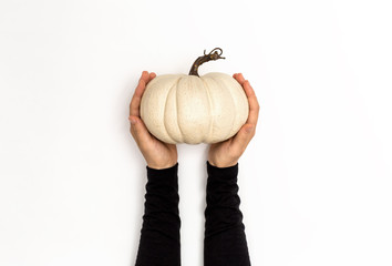 Hand holding a pumpkin on a white background