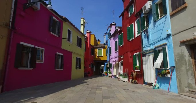 Medium shot of narrow alley amidst colourful houses, Venice, Italy