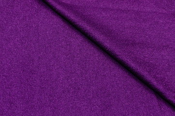 Fototapeta na wymiar Knitted fabric is dark purple