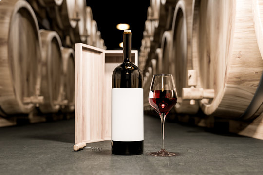 Wine glass and bottle on concrete wine cellar floor