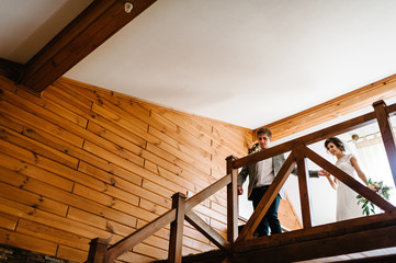 The groom holds the hand of his bride and down the stairs to the marriage ceremony. The best wedding day and marriage. Just married.