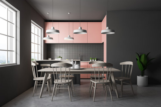 Gray tile kitchen with pink countertops, table