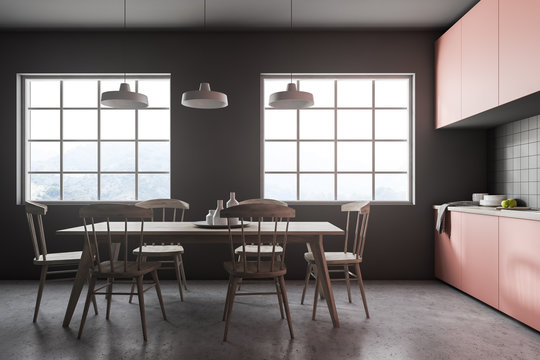 Wooden table in gray tile kitchen interior