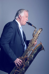 Fototapeta na wymiar Older man with a saxophone