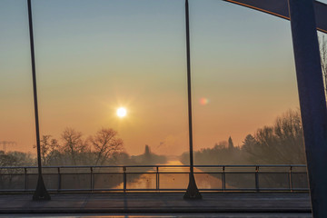 Sunrise over the waterway "Teltowkanal" in Berlin, Germany on a misty morning.