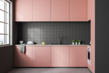 Gray tile kitchen interior, pink countertops