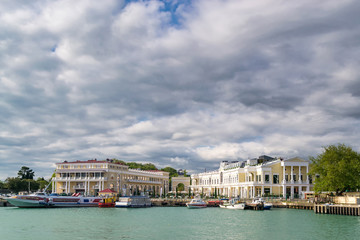 Obraz premium beautiful view of the sea Bay with yachts near the shore and thick clouds in the sky.
