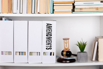 amendments concept. document folders and organizers, white book shelf