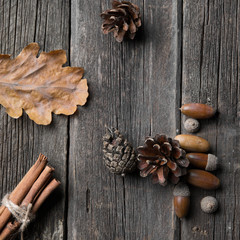 Autumn leaves on wooden background. yellow autumn leaves and acorns on the blackboard.