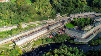 Aerial image of the village of New Lanark. A World Heritage Site in a deep valley next to the River Clyde.