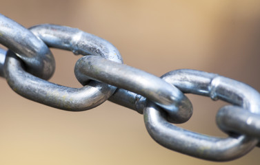 Steel chain on a beige background